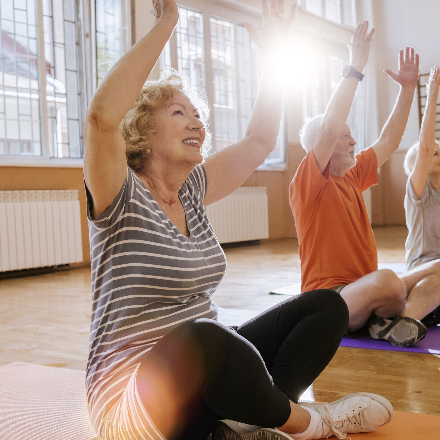 group of cheerful seniors having fun together exercising